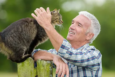 A man caressing his cat